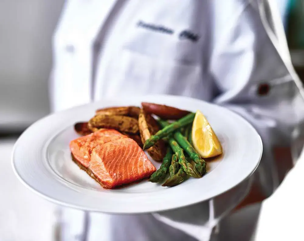 Parkrose Chateau Chef Created Meals, chef delivering a finished dish.