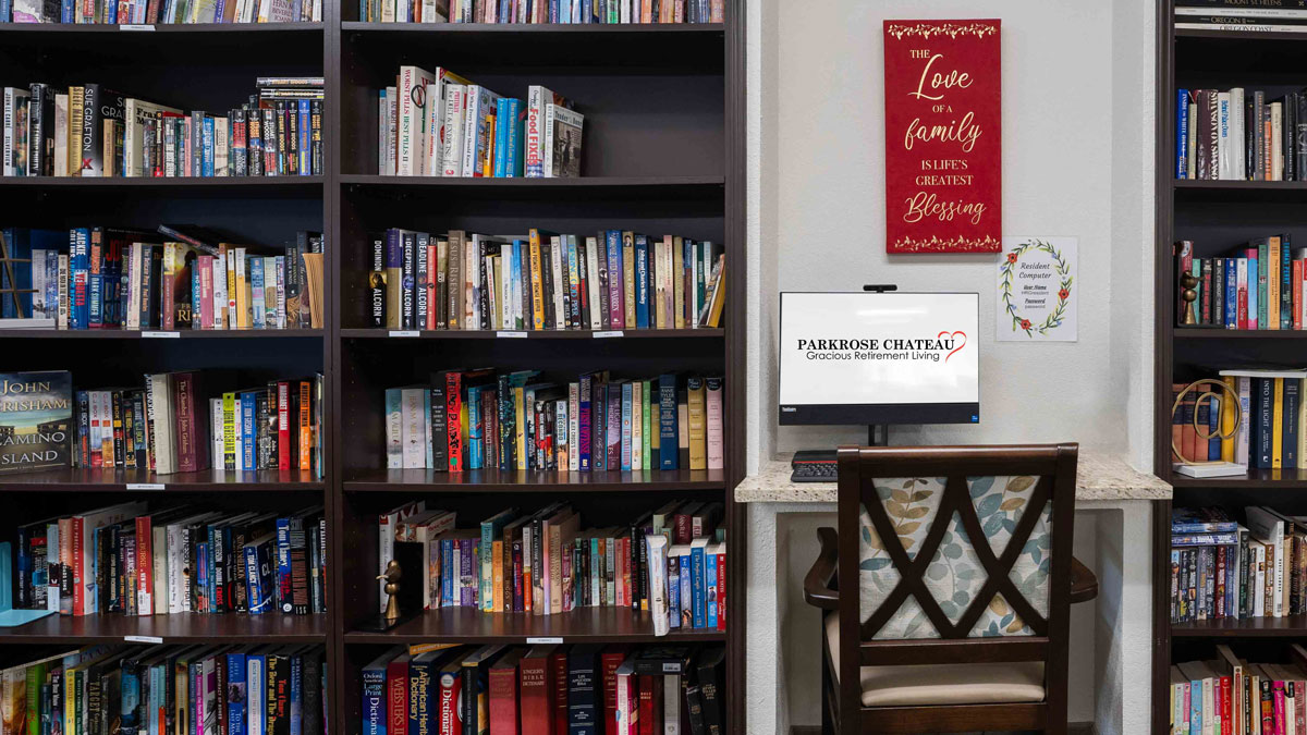The library at Parkrose Chateau with shelves of books and comfortable seating