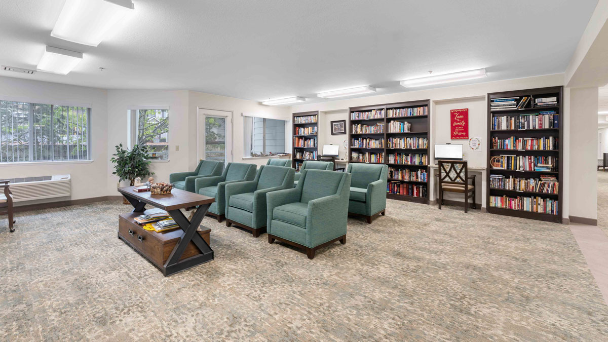 The library at Parkrose Chateau with shelves of books and comfortable seating